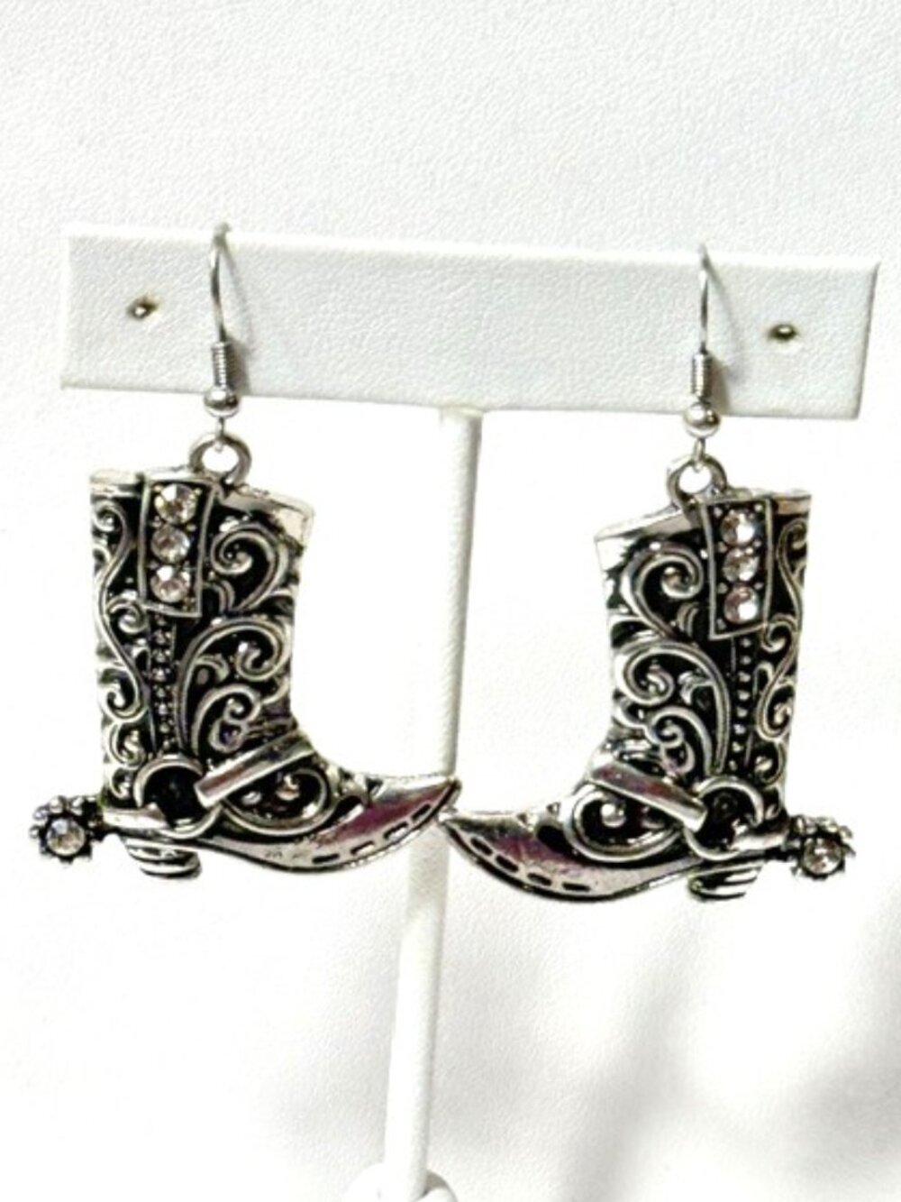 Alpaca silver and rhinestone cowboy boot pierced earrings.